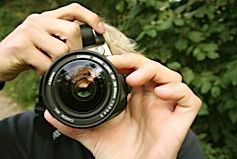 Photographer Focusing Camera Lens